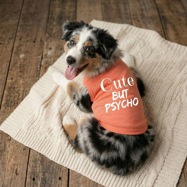 Dog wearing a pink shirt with &